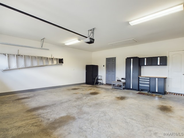 garage with a garage door opener and black fridge