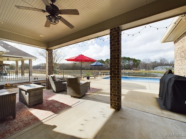 view of patio featuring a fenced in pool, area for grilling, and ceiling fan