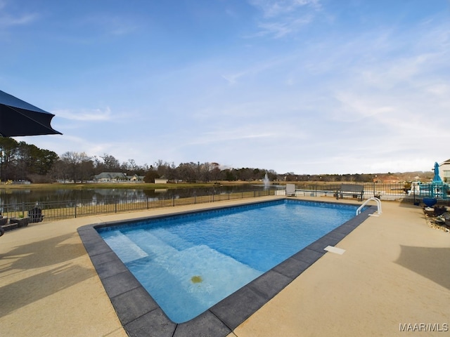 view of swimming pool featuring a patio and a water view