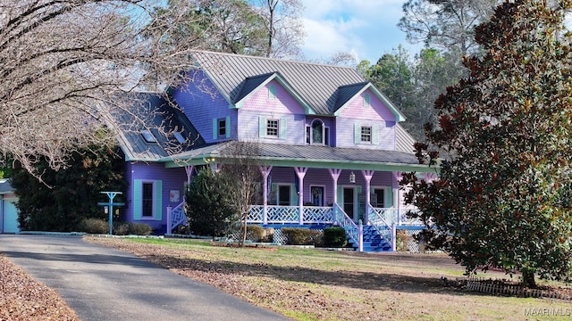 view of front of house with a front yard and a porch