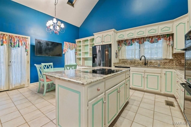 kitchen with a kitchen island, pendant lighting, sink, stainless steel fridge with ice dispenser, and black electric cooktop