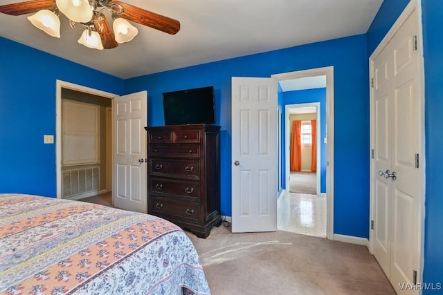 bedroom with ceiling fan and light carpet