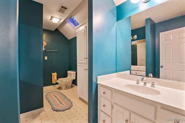 bathroom featuring vanity and lofted ceiling