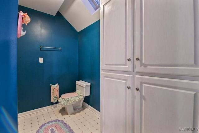 bathroom with vaulted ceiling and toilet