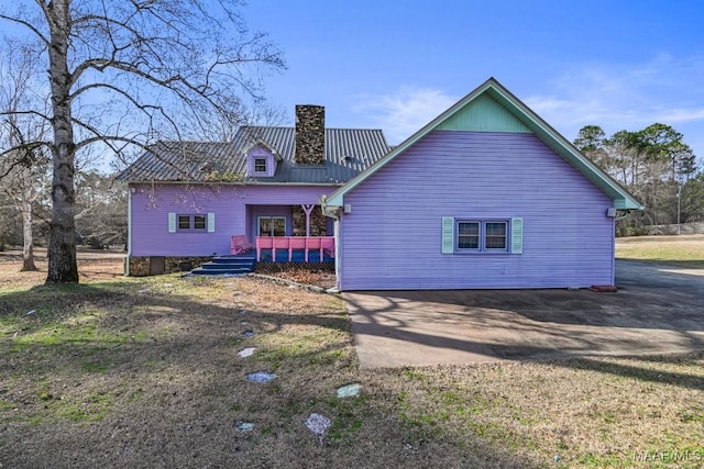 back of house with a deck