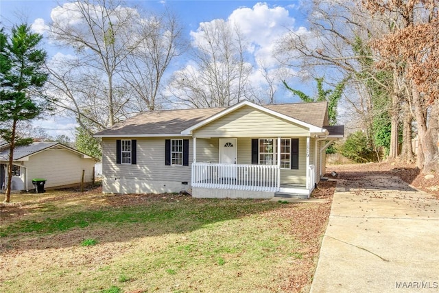 ranch-style home with covered porch and a front lawn