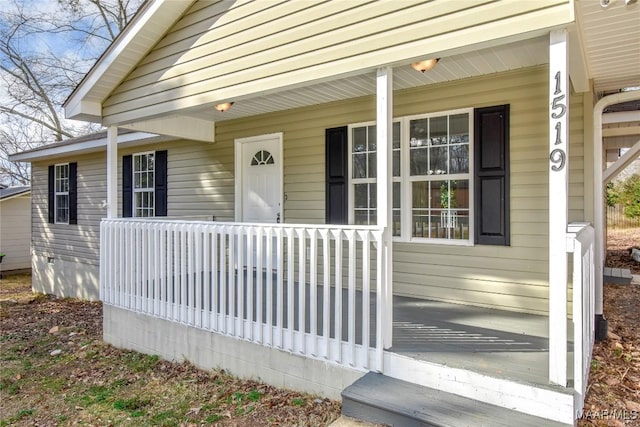 view of exterior entry featuring a porch