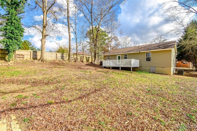 view of yard featuring a wooden deck and central air condition unit