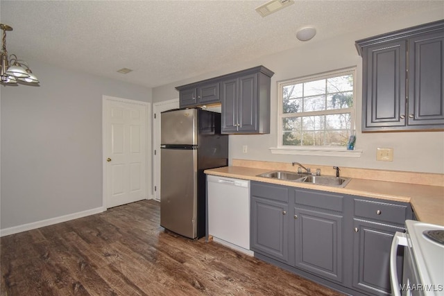 kitchen with sink, range with electric stovetop, stainless steel fridge, gray cabinets, and dishwasher