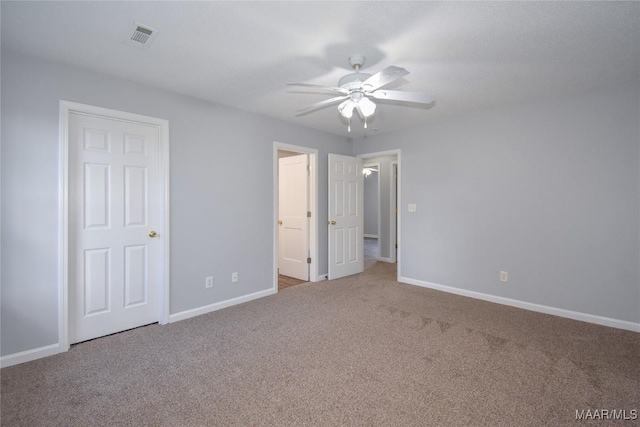 unfurnished bedroom with ceiling fan and carpet