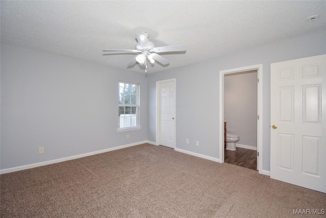 unfurnished bedroom with ensuite bathroom, carpet floors, ceiling fan, and a textured ceiling