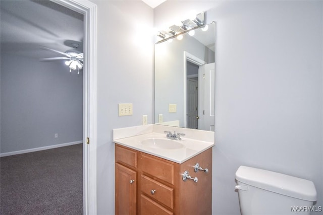 bathroom featuring ceiling fan, vanity, and toilet