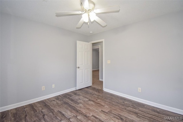 spare room with ceiling fan and dark hardwood / wood-style floors