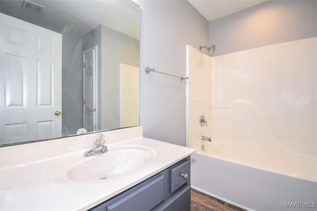 bathroom with washtub / shower combination and vanity