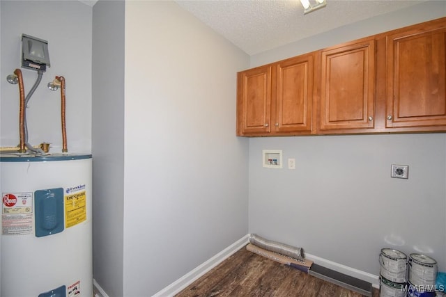 washroom with cabinets, a textured ceiling, hookup for a washing machine, electric water heater, and hookup for an electric dryer