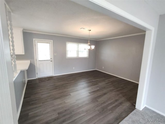 unfurnished dining area with ornamental molding and dark hardwood / wood-style floors