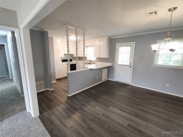 kitchen featuring pendant lighting, sink, white cabinetry, electric range, and ornamental molding