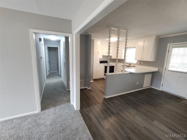 kitchen featuring dark hardwood / wood-style floors, decorative light fixtures, white cabinets, electric range, and kitchen peninsula