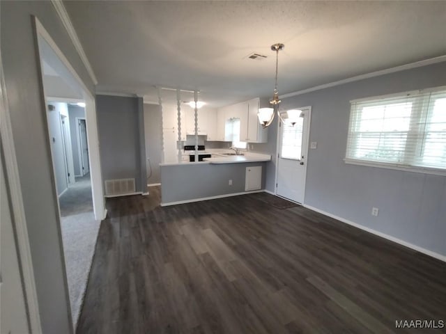 kitchen with sink, white cabinetry, hanging light fixtures, ornamental molding, and kitchen peninsula