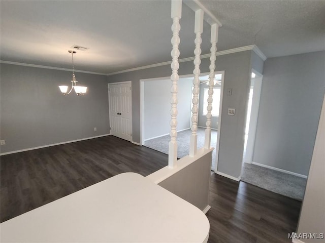 dining space with dark hardwood / wood-style flooring, crown molding, and a chandelier