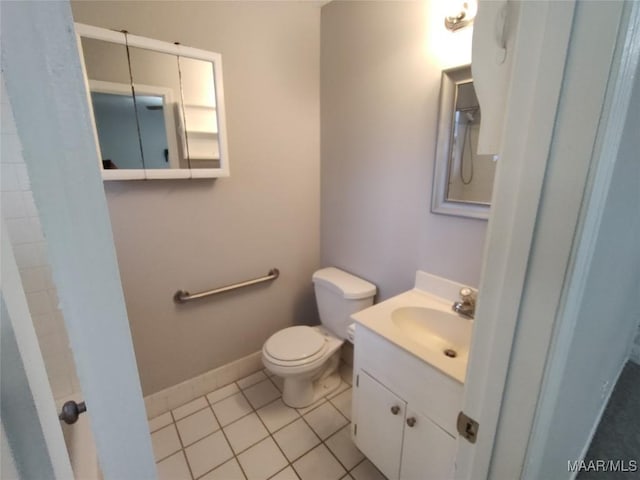 bathroom with tile patterned floors, vanity, and toilet