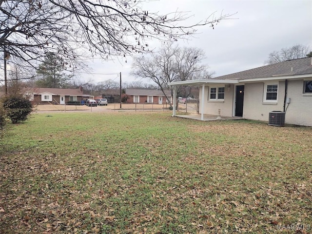 view of yard with central AC unit and a patio area