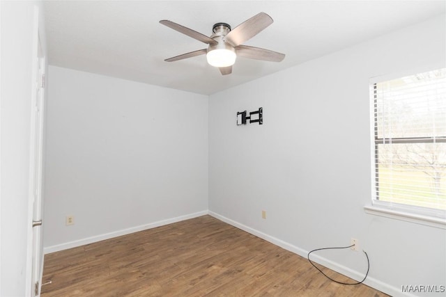 spare room featuring hardwood / wood-style flooring and ceiling fan