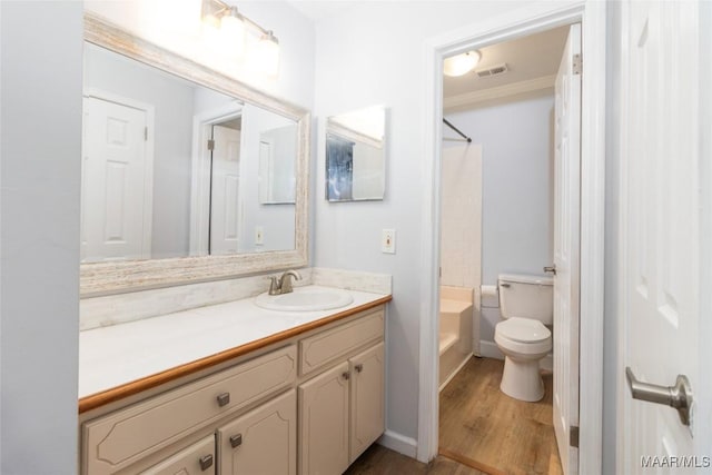 full bathroom with bathtub / shower combination, hardwood / wood-style flooring, vanity, toilet, and crown molding