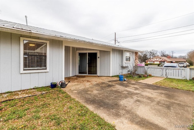 rear view of house with a yard and a patio area