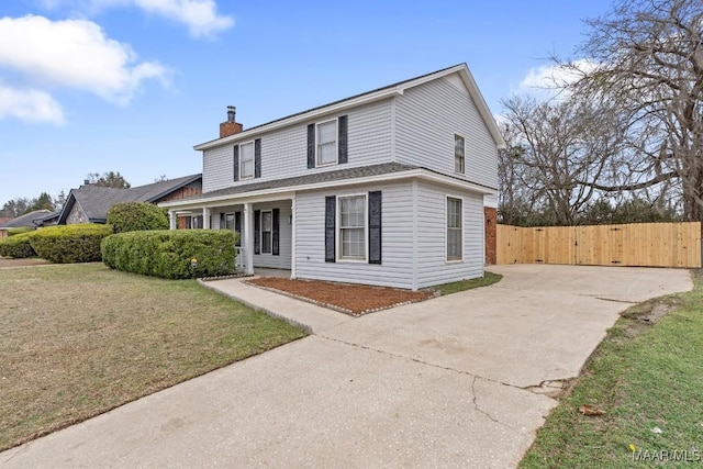 view of front facade featuring covered porch and a front yard