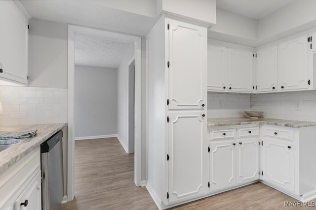 kitchen featuring dishwasher, light hardwood / wood-style floors, and white cabinets