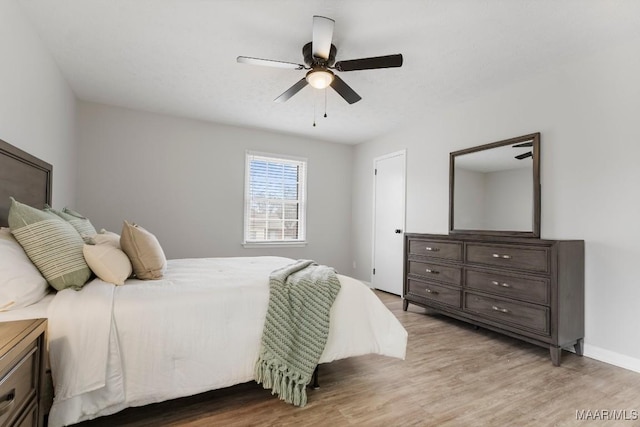 bedroom with light hardwood / wood-style flooring and ceiling fan