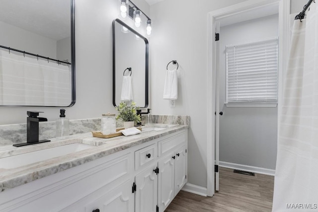 bathroom featuring hardwood / wood-style flooring and vanity