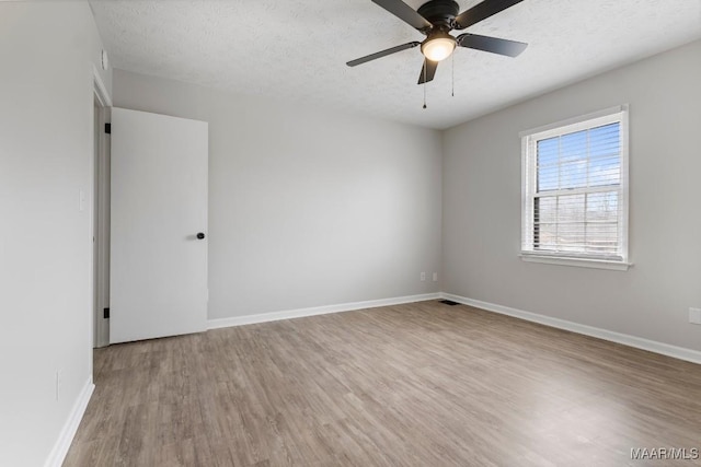 spare room with ceiling fan, hardwood / wood-style floors, and a textured ceiling