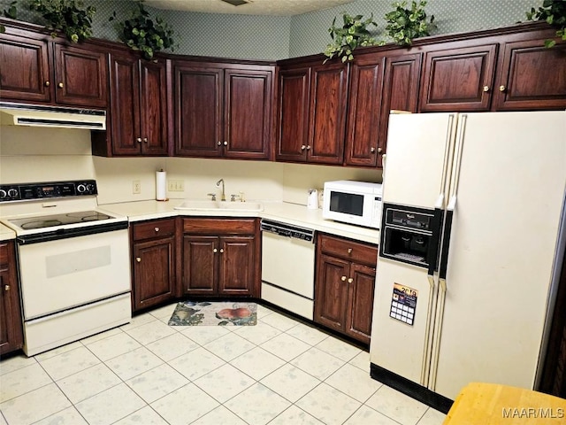 kitchen featuring white appliances and sink