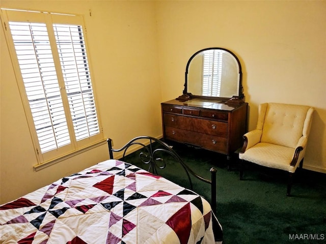 bedroom with carpet flooring and multiple windows