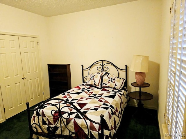 carpeted bedroom with a closet and a textured ceiling