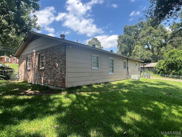 view of side of property with a yard