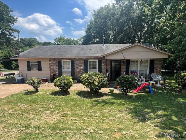 ranch-style home with covered porch and a front yard