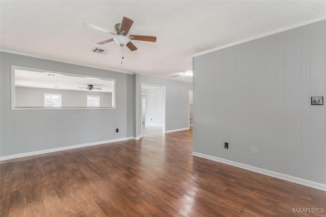 spare room with dark wood-type flooring, ceiling fan, and ornamental molding