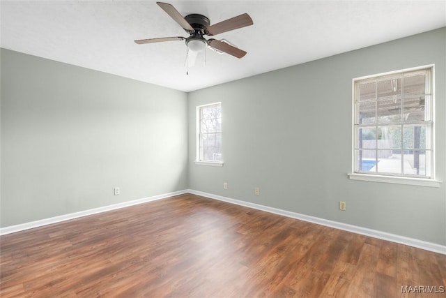 spare room featuring dark hardwood / wood-style floors and ceiling fan