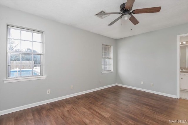 unfurnished room featuring dark wood-type flooring and ceiling fan