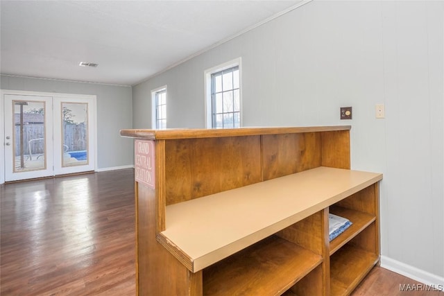 interior space featuring ornamental molding and dark hardwood / wood-style floors