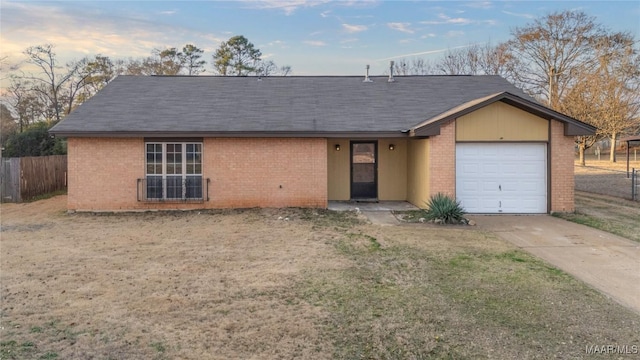 single story home featuring a garage and a front lawn