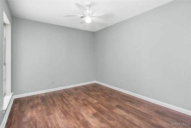 empty room with dark wood-type flooring and ceiling fan