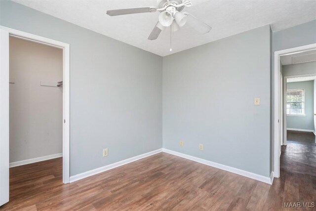 spare room featuring ceiling fan and dark hardwood / wood-style flooring