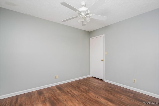 empty room with dark wood-type flooring and ceiling fan