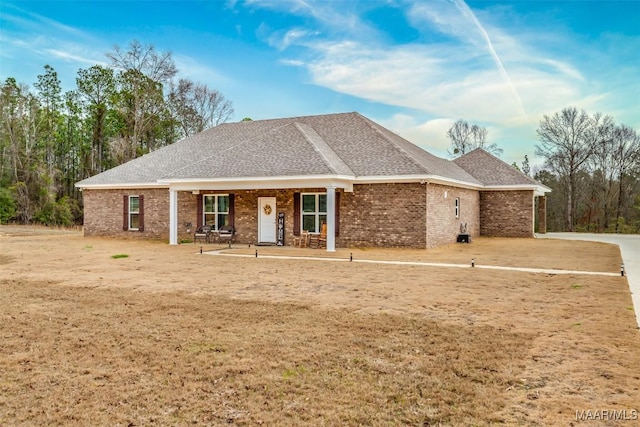 ranch-style house featuring a porch and a front lawn