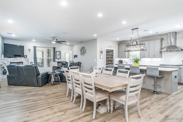 dining area with ceiling fan and light wood-type flooring