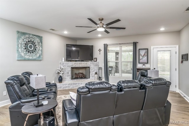 living room featuring hardwood / wood-style flooring and ceiling fan